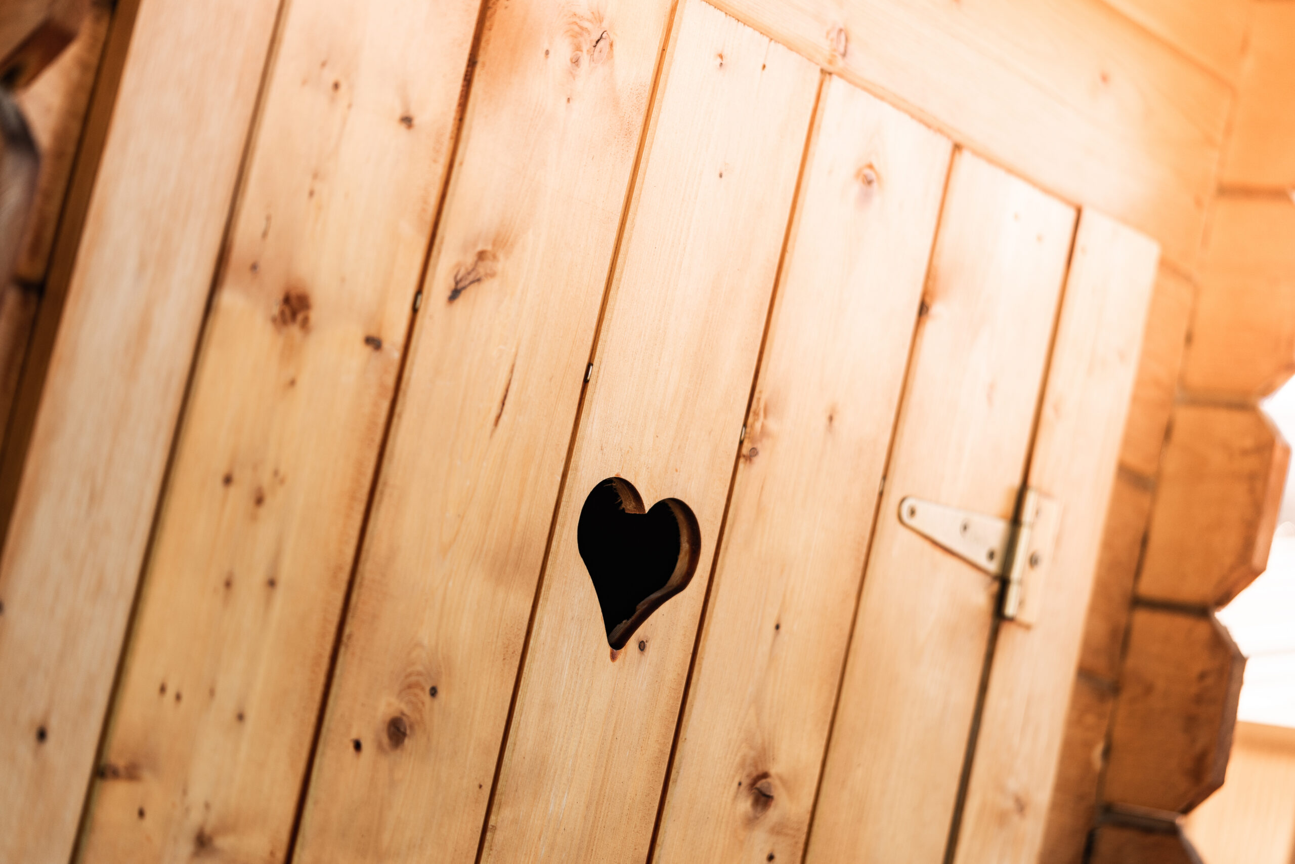 wooden-outdoor-toilet-with-a-carved-heart-in-the-door-picjumbo-com