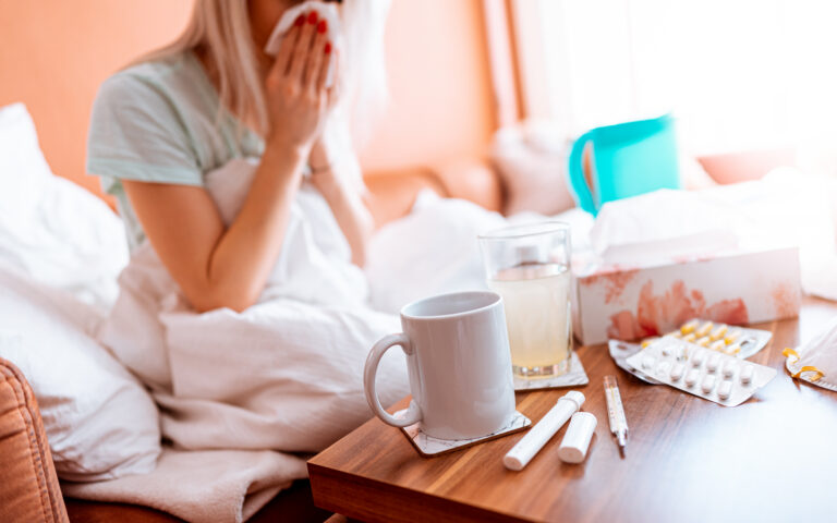 sick-woman-blowing-a-nose-while-sitting-on-a-bed-picjumbo-com
