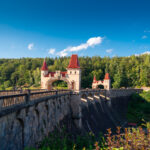 historic-stone-dam-with-red-roof-towers-in-forest-picjumbo-com
